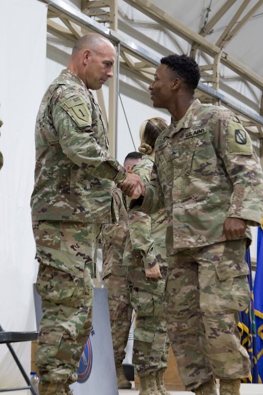 U.S. Army Command Sgt. Maj. Joseph Cornelison, command sergeant major of U.S. Army Central, congratulates a Soldier graduating the latest Basic Leader Course at Camp Buehring, Kuwait, Oct. 17, 2018. Developing a prepared and capable leader is one of the Army’s modernization efforts.