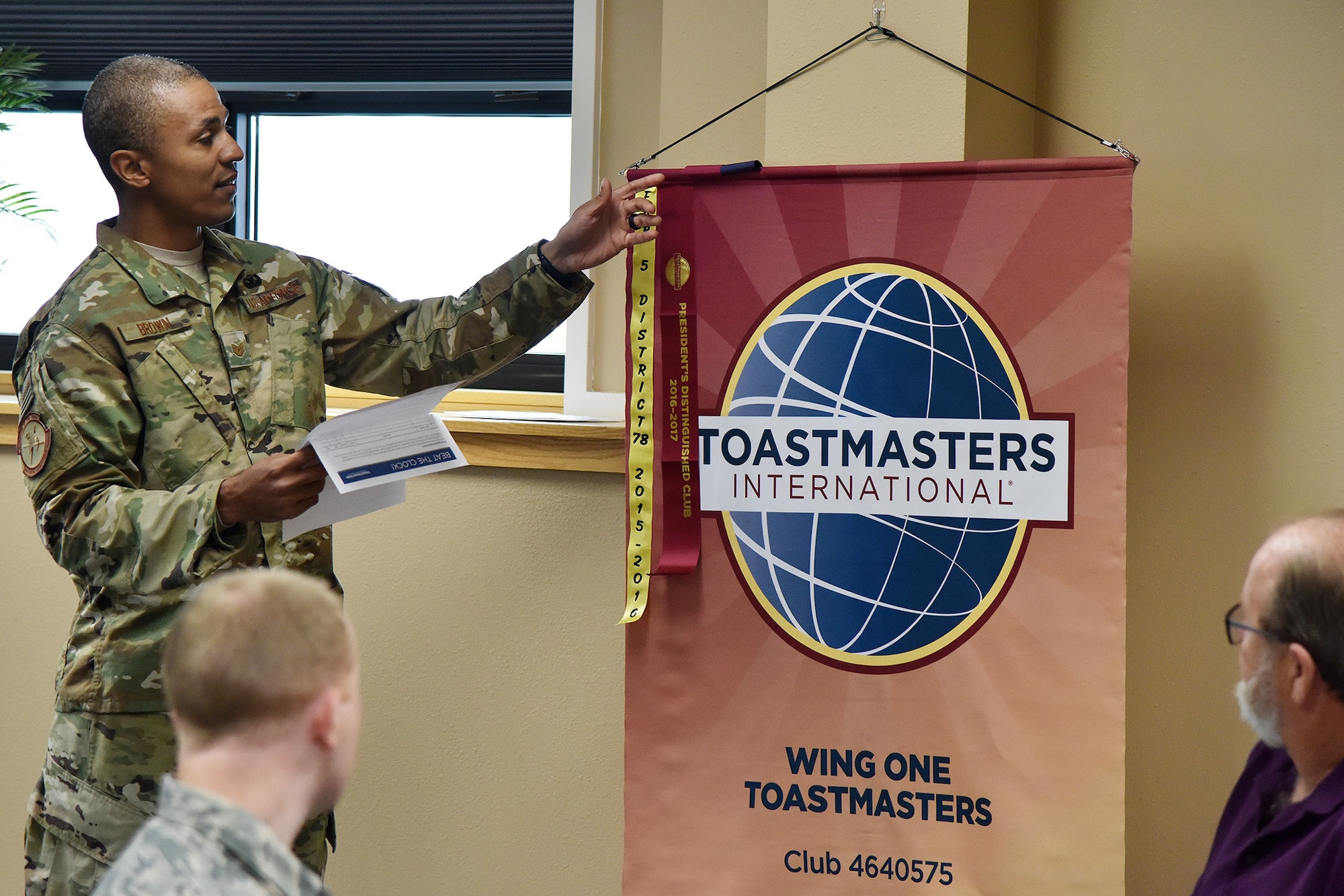 Tech. Sgt. Ritchie Brown, 741st Missile Security Forces Squadron member and Toastmasters president, unveils an accolade Nov. 7, 2018, at Malmstrom Air Force Base, Mont.