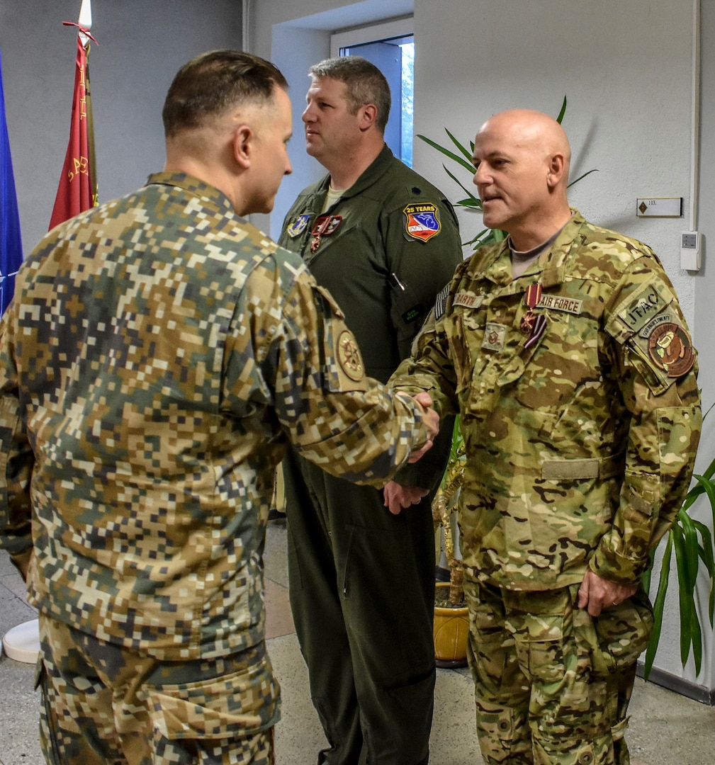 Master Sgt. Charles Barth, Grayling Air Gunnary Range, Mich., is decorated with the Commander of the Land Forces Medal for Merit, 3rd Class, at Ādaži Military Base, Latvia, Nov. 15, 2018. The awards were presented by Col. Ilmars Lejiņš, Land Forces Brigade Commander, National Armed Forces of Latvia. Ward and Barth received the honor for their contributions to the development of Latvia’s Joint Tactical Air Controller program.