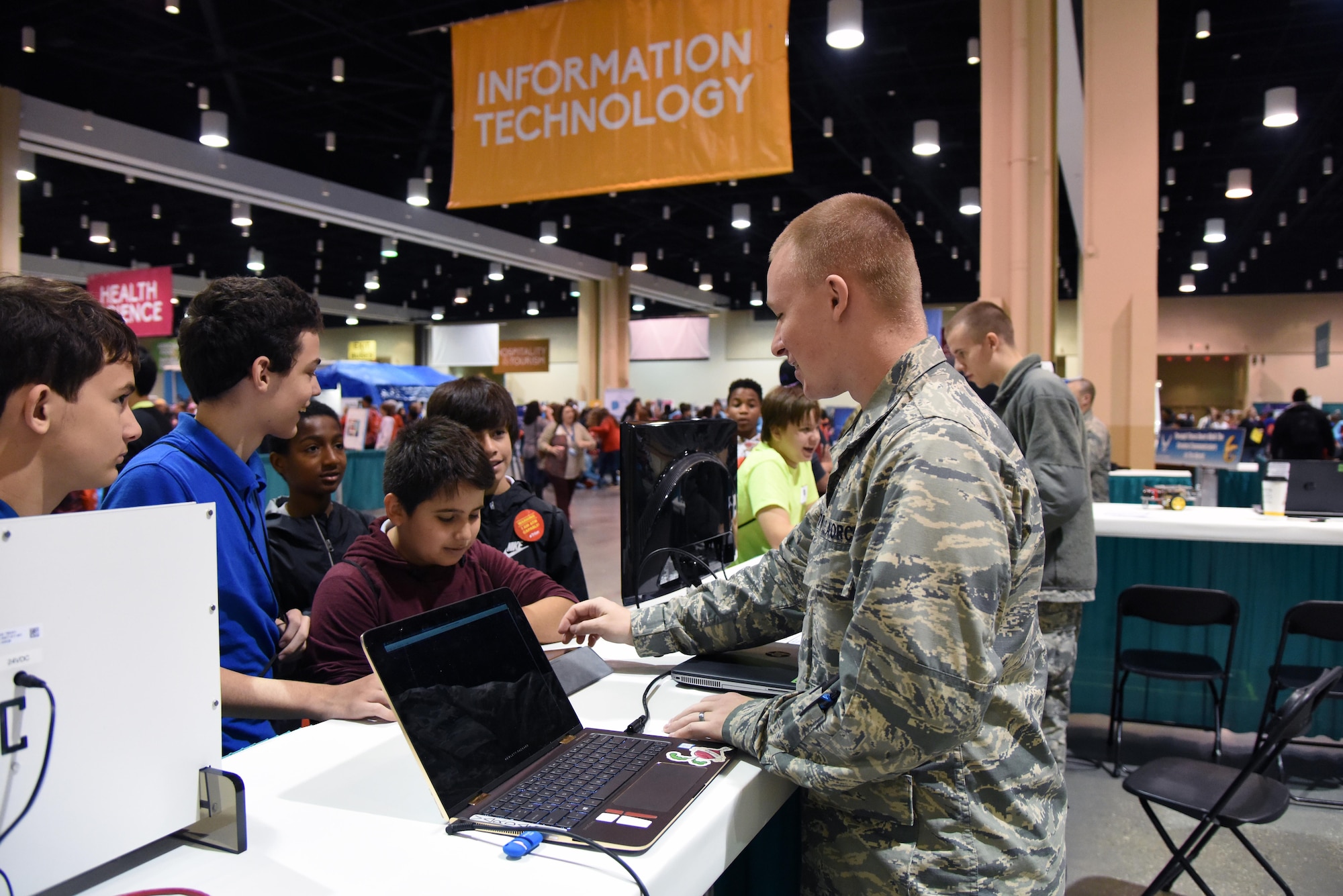 U.S. Air Force 2nd Lt. Colby Gilbert, 333rd Training Squadron cyber student, provides a cyber demonstration to St. Martin Middle School students during the Pathways to Possibilities event at the Mississippi Coast Coliseum in Biloxi, Miss., Nov. 4, 2018. The event is an interactive career expo designed for all eighth graders in private and public schools in the six lower counties of Mississippi. The purpose of the event, set forth by the Mississippi Department of Education, is to help encourage a direction for the students high school pathway choice and is linked to the Common Core state standards. (U.S. Air Force photo by Kemberly Groue)