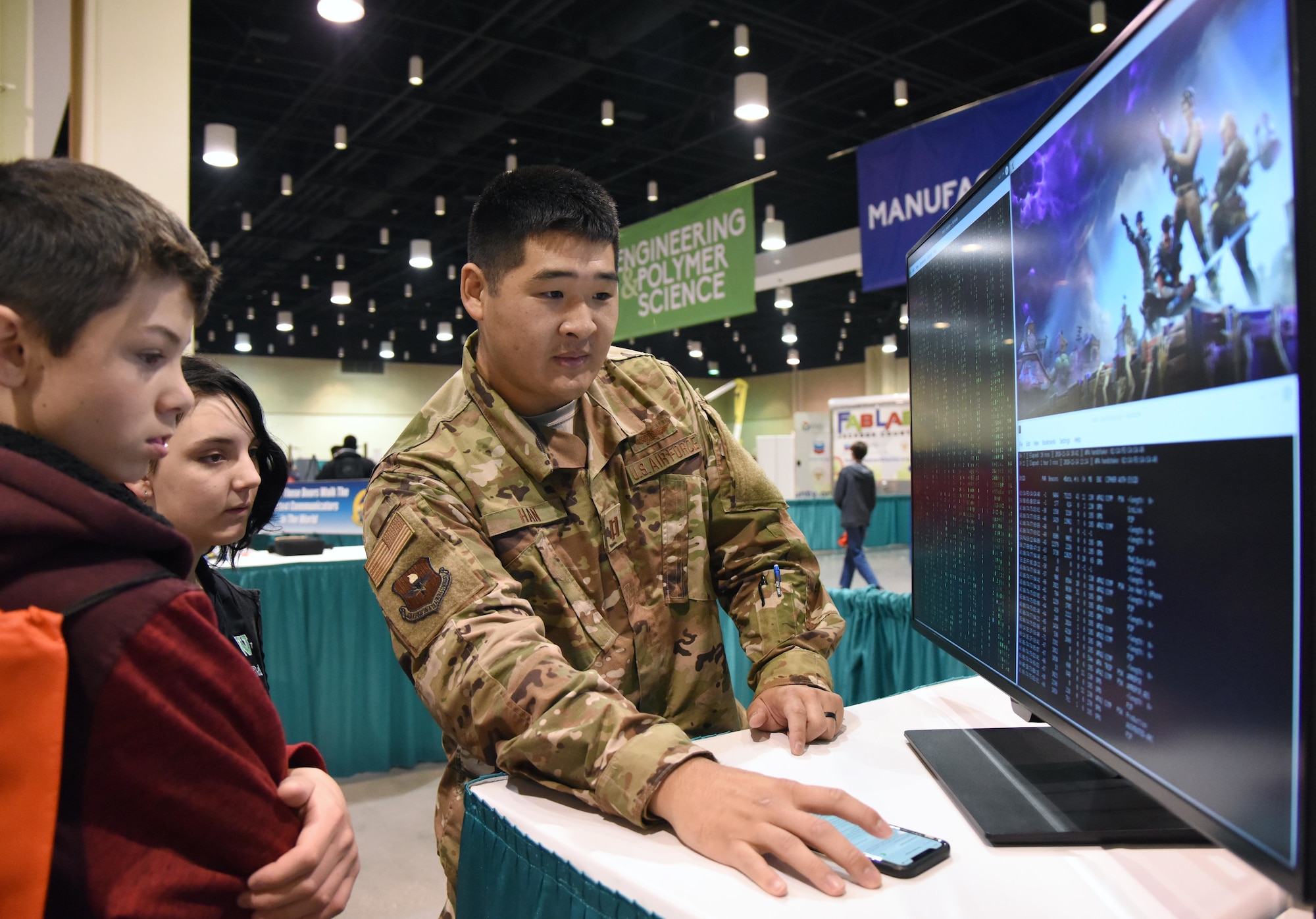 U.S. Air Force Capt. Jonathan Han, 333rd Training Squadron instructor, provides a cyber demonstration to West Wortham Middle School students during the Pathways to Possibilities event at the Mississippi Coast Coliseum in Biloxi, Miss., Nov. 14, 2018. The event is an interactive career expo designed for all eighth graders in private and public schools in the six lower counties of Mississippi. The purpose of the event, set forth by the Mississippi Department of Education, is to help encourage a direction for the students high school pathway choice and is linked to the Common Core state standards. (U.S. Air Force photo by Kemberly Groue)