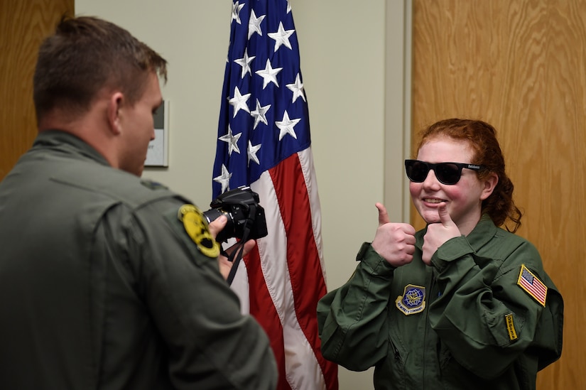 Fallon Emery, a new honorary member of the 437th Operations Support Squadron, approves her official photo after arriving at the 437th OSS facility Nov. 7, 2018, at Joint Base Charleston, S.C., as part of the Airman for a Day program.