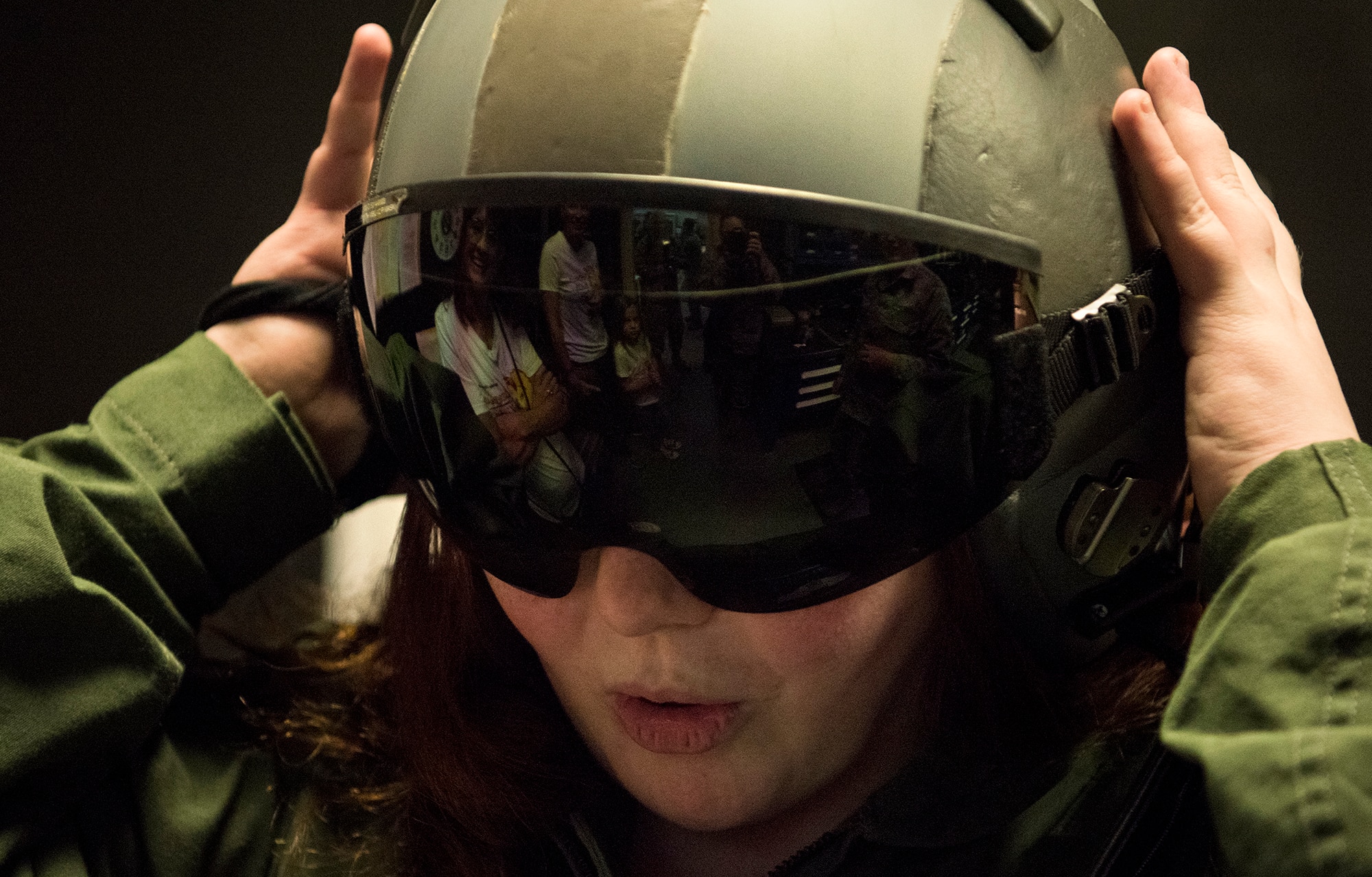 Fallon Emery, a new honorary member of the 437th Operations Support Squadron, tries on a flight helmet at the Aircrew Flight Equipment facility Nov. 7, 2018, at Joint Base Charleston, S.C., as part of the Airman for a Day program.