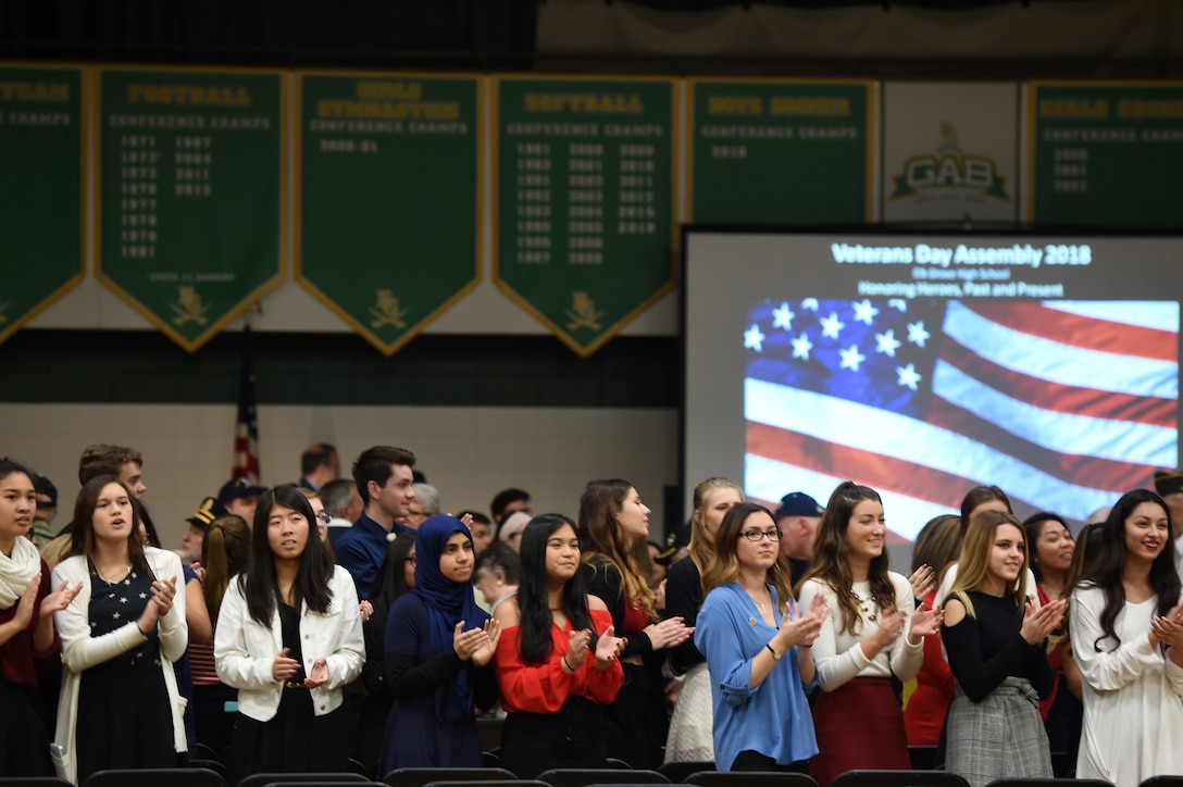 High school students from Elk Grove High School applaud veterans as they arrive during the Elk Grove High School Veterans Day ceremony, Nov. 9, 2018.