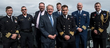 Charleston Mayor John Tecklenburg and Cmdr. Will King, commanding officer of the HMS Monmouth, stand on the quarterdeck of the ship with Joint Base Charleston leaders, HMS Monmouth officers and local community leaders during the ship’s visit Nov. 8-12, 2018. The Monmouth participated in several events throughout Veterans Day weekend with the Joint Base Charleston community.