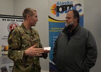 Maj. Cal Gentry, 354th Contracting Squadron commander, talks with an Alaskan business owner at an Interior Alaska Industry Day event in Fairbanks, Alaska, Nov. 14, 2018. During the industry event, Air Force and Army contracting officers forecasted 60 construction projects for interior Alaska during fiscal year 2019. (U.S. Air Force photo by Capt. Kay M. Nissen)