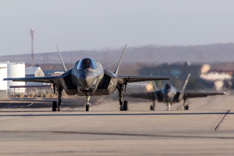 Two F-35s taxi down a taxi-way at Edwards Air Force Base, Aug. 16, 2017. The 461st Flight Test Squadron have recently begun flight testing the Automatic Ground Collision Avoidance System (Auto GCAS) onboard the F-35 aircraft. (U.S. Air Force photo by Darin Russel)