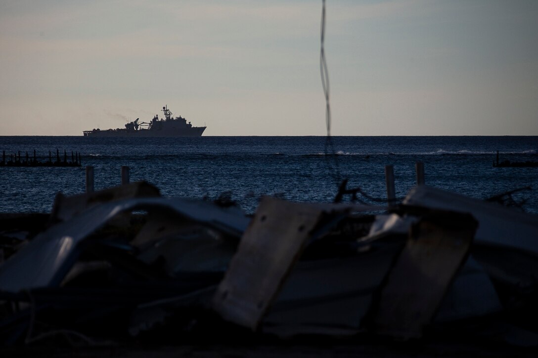 The dock landing ship USS Ashland (LSD 48) sits idle off the coast during the U.S. Defense Support of Civil Authorities relief effort in response to Super Typhoon Yutu, Tinian, Commonwealth of the Northern Mariana Islands, Nov. 3, 2018. Businesses, government buildings, homes and schools were heavily damaged by Super Typhoon Yutu, which made a direct hit with devastating effect on Tinian Oct. 25 packing 170 MPH winds – it is the second strongest storm to ever hit U.S. soil and the strongest storm of 2018. Marines with the 31st Marine Expeditionary Unit and CLB-31 have been leading a multi-service contingent since Oct. 29 as part of the U.S. Federal Emergency Management Agency-directed DSCA mission here. The Ashland arrived today to deliver a larger contingent of Marines and Seabees to further assist the people of Tinian. The Marines arrived at the request of CNMI officials and FEMA to assist relief efforts in the wake of Yutu, the largest typhoon to ever hit a U.S. territory. The 31st MEU, the Marine Corps’ only continuously forward-deployed MEU, provides a flexible force ready to perform a wide-range of military operations across the Indo-Pacific region. (U.S. Marine Corps photo by Gunnery Sgt. T. T. Parish/Released)