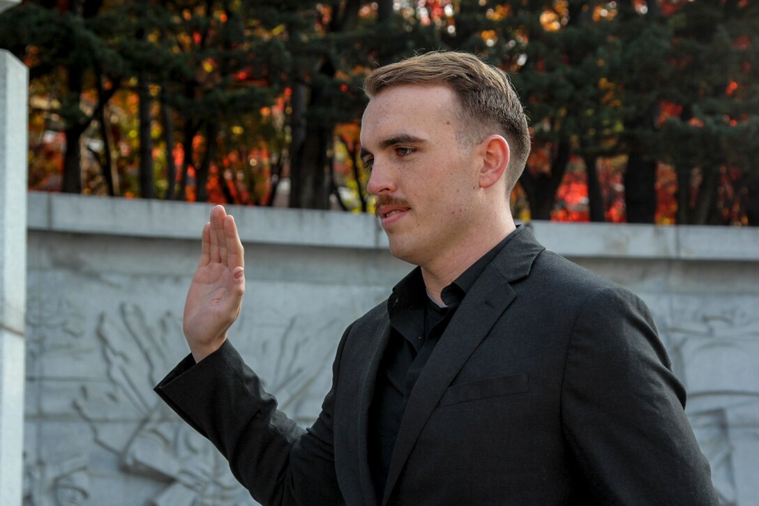 INCHEON, Republic of Korea – Cpl. Ryan Kincannon, G-6 cyber network administrator, recites the oath of enlistment during his reenlistment ceremony here, Nov. 14. Kincannon made his pledge to serve another 4 years in the Marine Corps standing atop a hill once occupied as the command post for Lewis B. “Chesty” Puller during the Battle for Inchon. (Official Marine Corps photo by Sgt. Nathaniel Hanscom/Released)