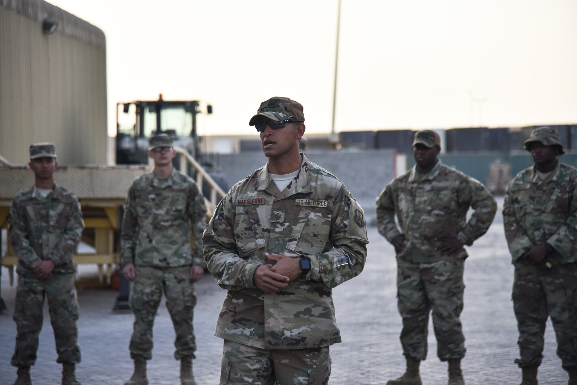 U.S. Air Force Master Sgt. Jason Napoleoni, 380th Expeditionary Logistics Readiness Squadron ground transportation superintendent, speaks to the 380th ELRS during a tribute to the fallen ground transportation Airmen at Al Dhafra Air Base, United Arab Emirates, Nov. 8, 2018. Napoleoni brought the tradition from his home unit at Dyess Air Force Base, Texas, to ADAB, that originated at Camp Bullis, Texas, in 2004. (U.S. Air Force photo by Senior Airman Mya M. Crosby)