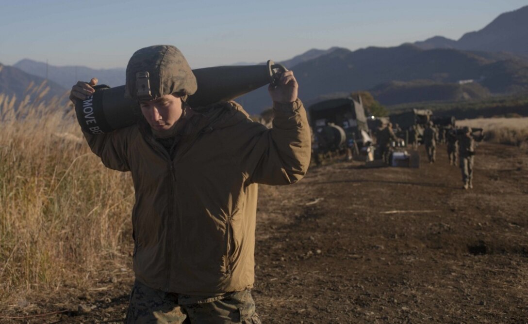 Lance Cpl. Dayton Hulsey a field artillery control Marine with Alpha Battery, 3rd Battalion, 12th Marine Regiment, helps conduct an ammunition transfer for the M777A2 155mm Howitzer during Artillery Relocation Training Program 18-3 October 30, 2018, on Combined Arms Training Complex, Camp Fuji, Japan.