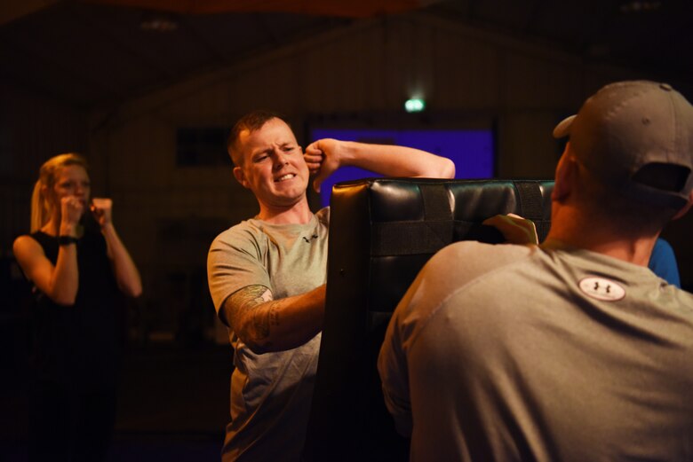 A Survival, Evasion, Resistance and Escape specialist, assigned to the 48th Operation Support Squadron, demonstrates a hammer fist strike at a self-defense class for women on Royal Air Force Mildenhall, England, Nov. 14, 2018. Attendees had the chance to practice strikes, chokes and other vital defensive tactics. (U.S. Air Force photo by Airman 1st Class Shanice Williams-Jones)