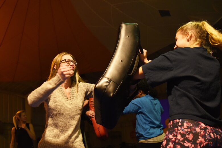 Attendees of a self-defense class practice proper striking techniques at Royal Air Force Mildenhall, England, Nov. 14, 2018. The women-only class was hosted by the 48th Survival, Evasion, Resistance and Escape specialists. (U.S. Air Force photo by Airman 1st Class Shanice Williams-Jones)