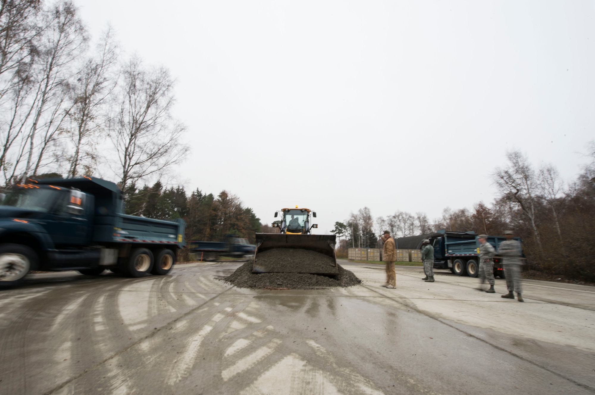 U.S. Airmen assigned to the 786th Civil Engineer Squadron move a gravel pile as part of a training event on Ramstein Air Base, Germany, Nov. 15, 2018. Leaders at the 786th CES bolstered their squadron’s Prime Base Engineer Emergency Force readiness with assistance from instructors assigned to the 435th Construction and Training Squadron. (U.S. Air Force photo by Senior Airman Joshua Magbanua)