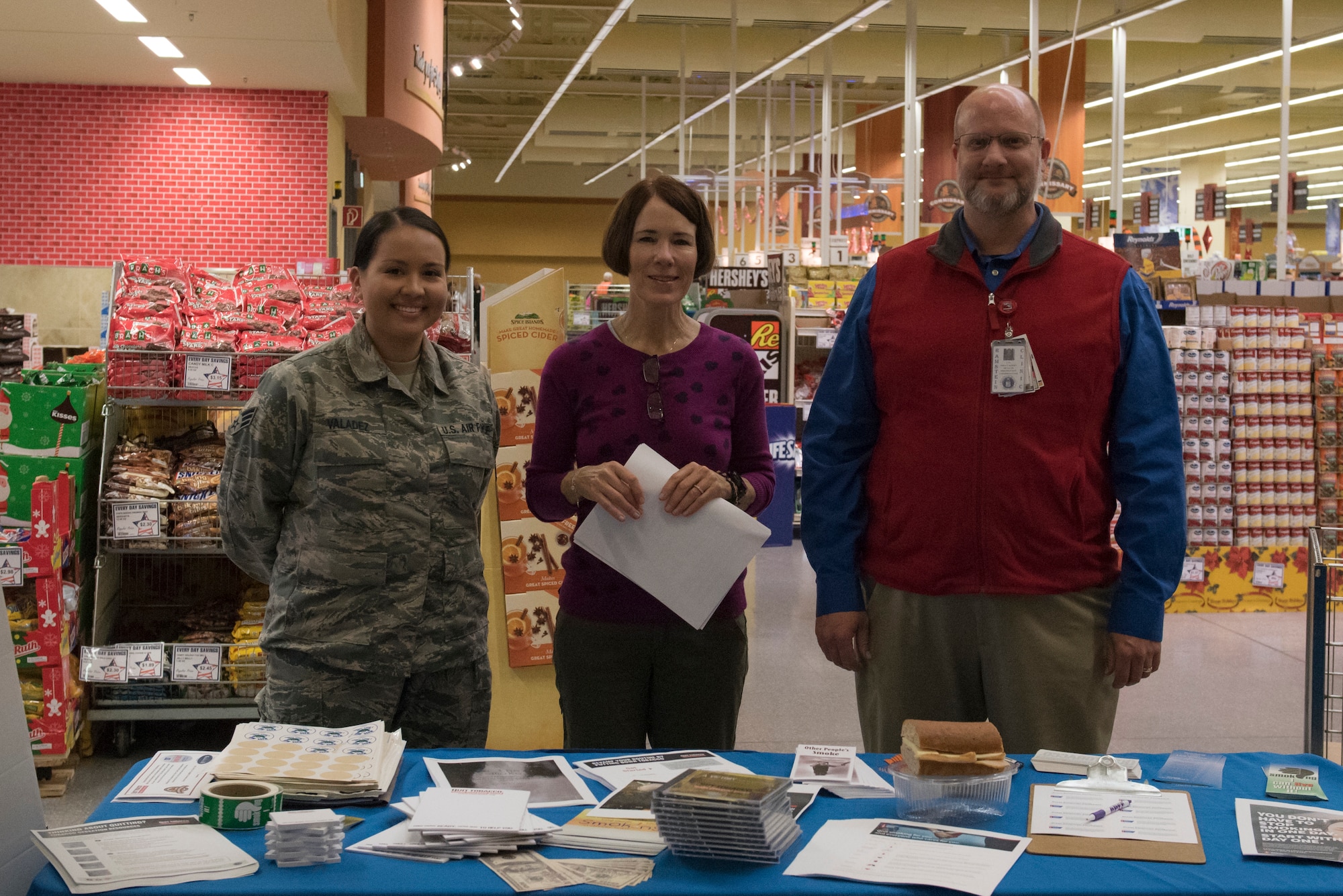 From left, U.S. Air Force Senior Airman Rebecca Valadez 86th Airlift Wing Dental Squadron dental assistant, Charlie Engeman, Health Promotion volunteer, and Brian Kirby, 86th Medical Group Health Promotion coordinator, pose for a photo during the Great American Smokeout event on Ramstein Air Base, Germany, Nov 15, 2018. The event presented an opportunity for smokers to dispose of their tobacco for a free turkey sandwich and pledge to quit smoking. (U.S. Air Force photo by Airman 1st Class Kaylea Berry)