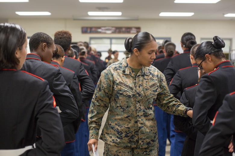 Sgt. Cristal Abregomedina, a warehouse clerk with Headquarters and Service Battalion, examines the uniforms of Marines from November Company, 4th Recruit Training Battalion Nov. 9, 2018 at Marine Corps Recruit Depot Parris Island, S.C. (Official Marine Corps Photo by Staff Sgt. Tyler Hlavac)
