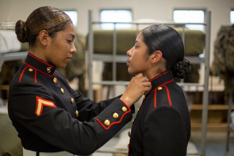 Pfc. Kathy Espinoza, from New York City, N.Y. inspects the uniform of Pvt. Arella Aleman, from Dallas, Texas Nov. 9, 2018 at Marine Corps Recruit Depot Parris Island, S.C. (Official Marine Corps Photo by Staff Sgt. Tyler Hlavac)