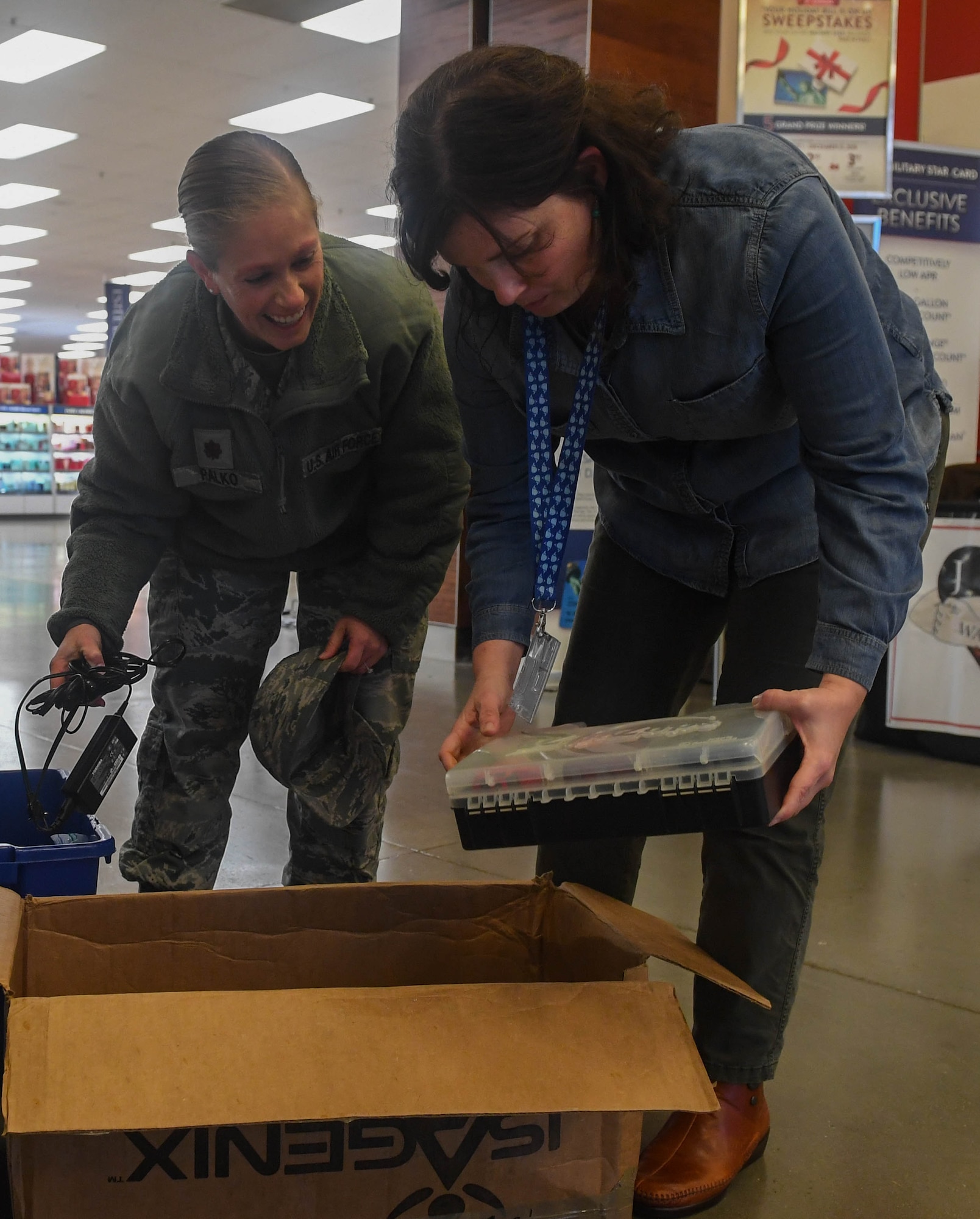 Alicia Garcia, 633rd Civil Engineer Squadron installation management flight natural resources program manager, looks through recyclable items brought in by U.S. Air Force Maj. Jennifer Palko, 733rd Logistics Readiness Squadron director of operations, during America Recycles Day at Joint Base Langley-Eustis, Virginia, Nov. 15, 2018. The 733rd Civil Engineer Division started a six-month recycling program on Nov. 1, 2018 that will end during Earth Week in April 2019. (U.S. Air Force photo by Senior Airman Derek Seifert)
