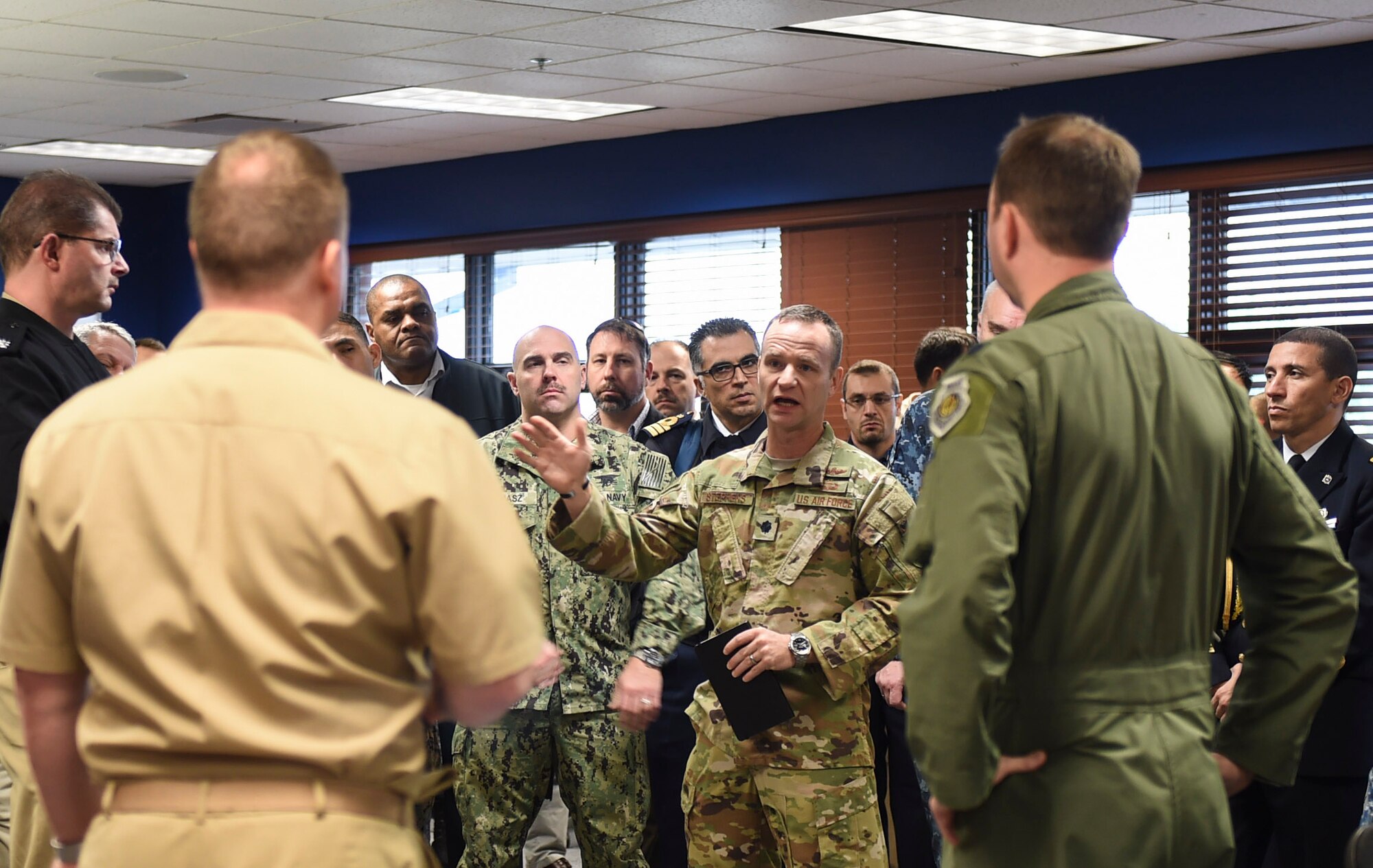 A group of Naval War College students, comprised of 56 foreign and joint military officers, discuss air mobility operations during a Nov. 13, 2018, visit to Joint Base Charleston, S.C.