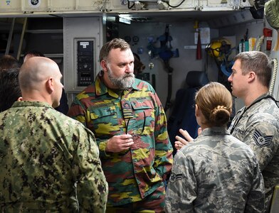 Joint and foreign nation naval officers attending the U.S. Naval War College discuss the capabilities of the C-17 Globemaster III aircraft with Joint Base Charleston Airmen during a Nov. 13, 2018, visit to JB Charleston, S.C.