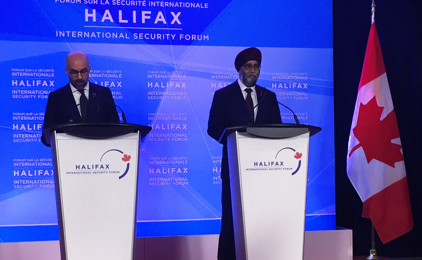 Peter Van Praagh, president of the Halifax Forum, and Canadian Defense Minister Harjit Sajjan discuss security challenges that will be aired at the Halifax International Security Forum during a press conference in Halifax, Nova Scotia.