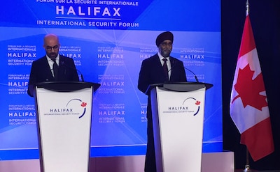 Peter Van Praagh, president of the Halifax Forum, and Canadian Defense Minister Harjit Sajjan discuss security challenges that will be aired at the Halifax International Security Forum during a press conference in Halifax, Nova Scotia.