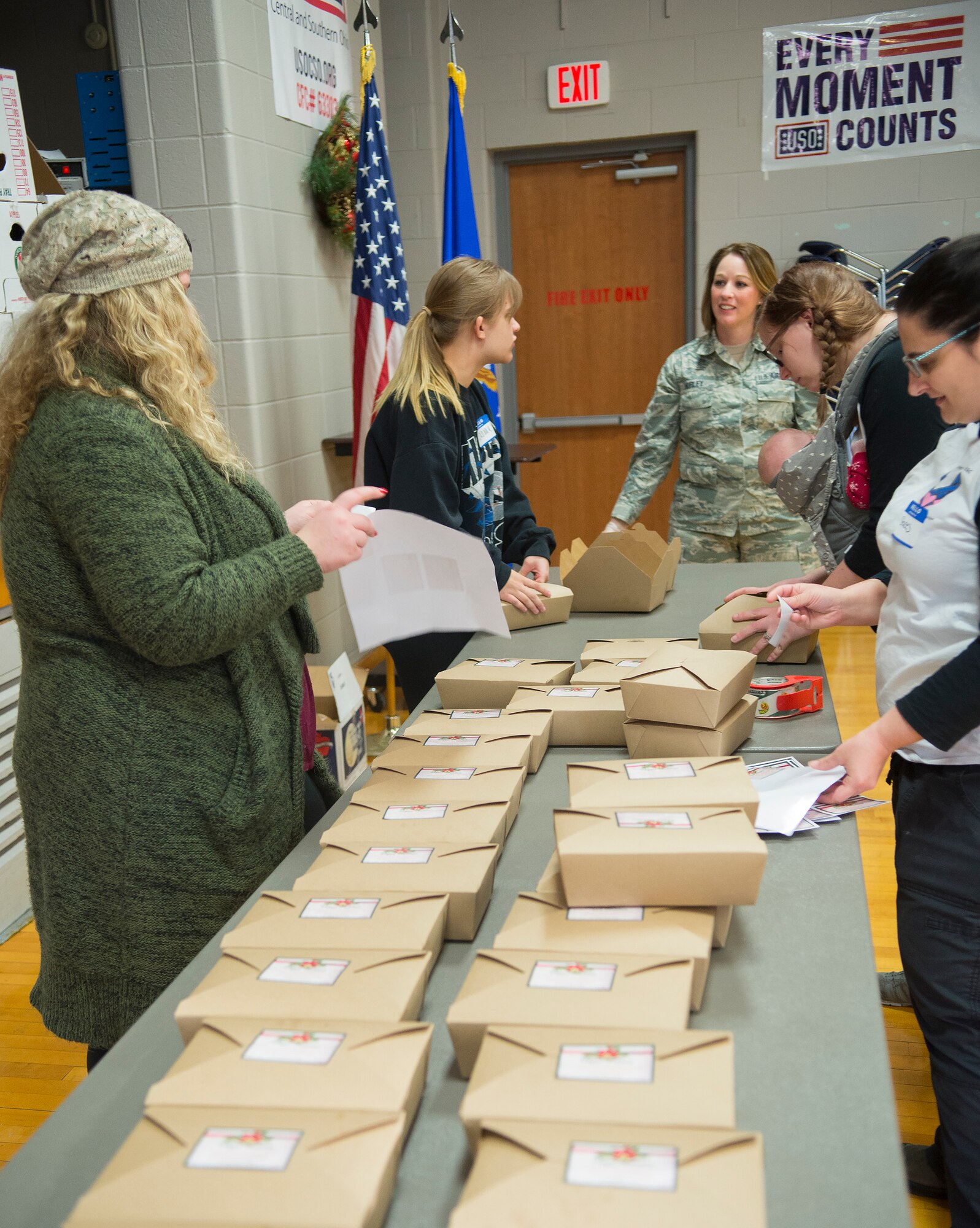 Tech. Sgt. Season Hurley, 88th Medical Support Squadron, and others pack an assortment of homemade cookies into boxes Dec. 6, 2017, at the Wright-Patterson Air Force Base USO Community Center during the annual cookie drive. Boxes of donated cookies are to be distributed this holiday season to some 1,100 unaccompanied Airmen. (U.S. Air Force photo/R.J. Oriez)