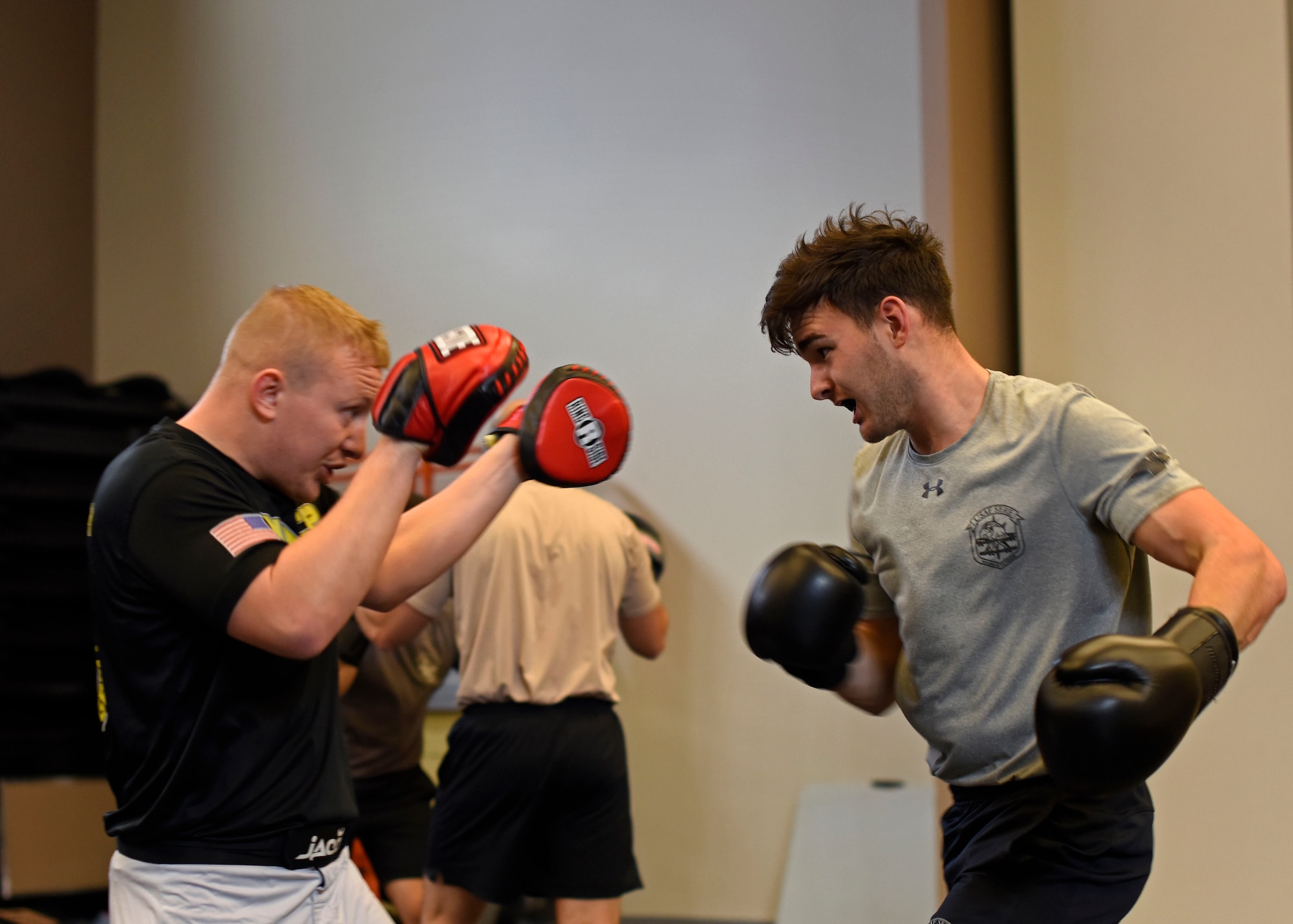 U.S Air Force Senior Airman Skyler Pendleton, 22nd Training Squadron Survival, Evasion, Resistance and Escape specialist and SERE Combatives Program instructor, blocks punches from Airman 1st Class Justin Croteau, 22nd TRS SERE specialist, during a four-hour block of combative training at Fairchild Air Force Base, Washington, Nov. 7, 2018. The 80-hour program trains on projectile, striking, clenching and grappling self-defense techniques. (U.S. Air Force photo/Airman 1st class Jesenia Landaverde)