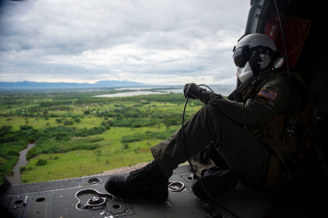 Naval Aircrewman (Helicopter) 2nd Class Nicholas Glass, from Salisbury, N.C., looks out across the Colombian landscape from aboard an MH-60S Seahawk.