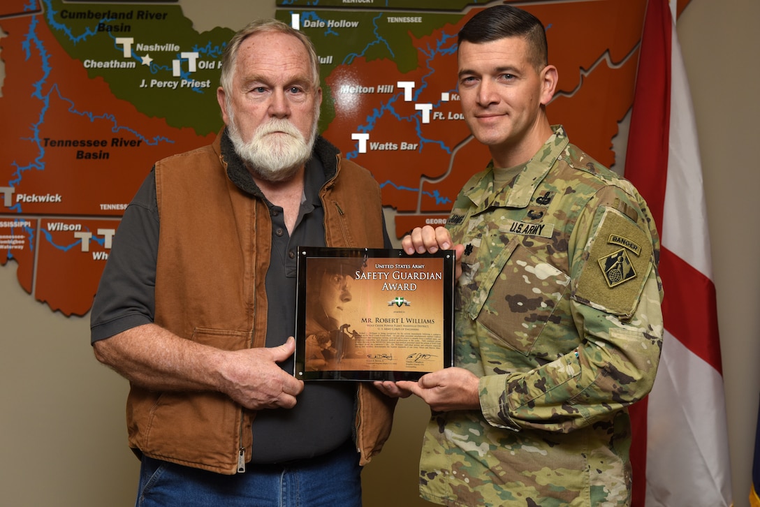 Lt. Col. Cullen Jones, U.S. Army Corps of Engineers Nashville District commander, presents the United States Army Safety Guardian Award to Robert Williams, Wolf Creek Dam Power Plant shift operator, during a ceremony Nov. 15, 2018 at the Nashville District Headquarters in Nashville, Tenn. Williams is one of five employees whose quick actions to evacuate an injured contractor from a confined space July 9, 2018 at Wolf Creek Dam in Jamestown, Ky., reduced the time it took for the victim to receive life-saving medical treatment. (USACE photo by Lee Roberts)