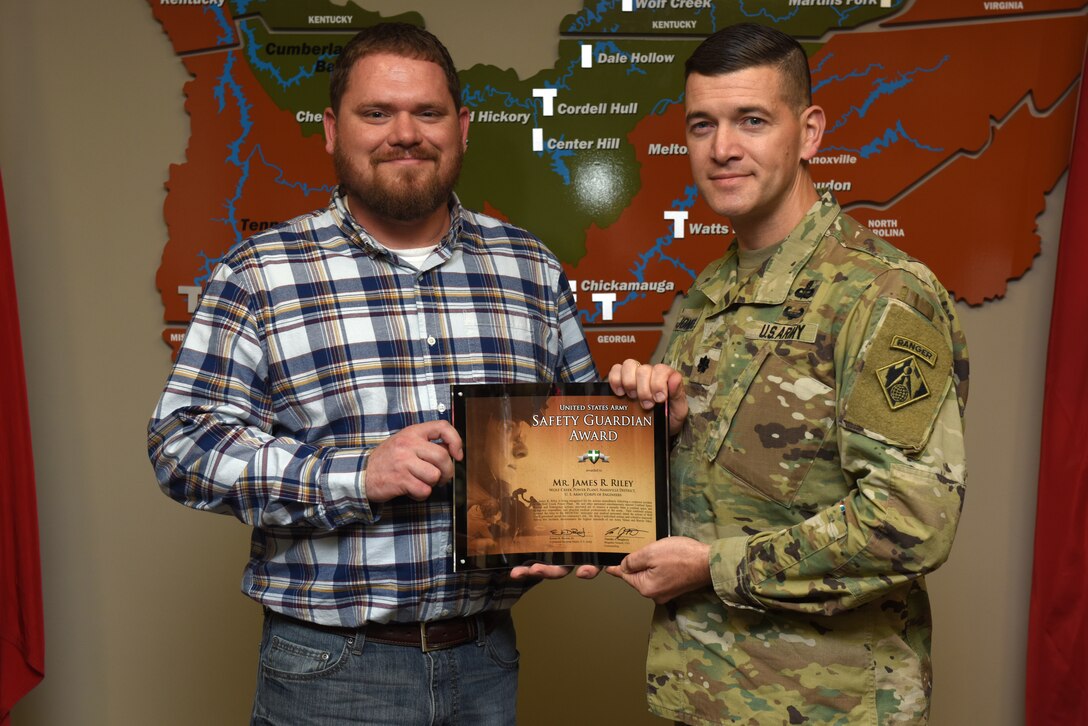 Lt. Col. Cullen Jones, U.S. Army Corps of Engineers Nashville District commander, presents the United States Army Safety Guardian Award to James Riley, Wolf Creek Dam Power Plant operator trainee, during a ceremony Nov. 15, 2018 at the Nashville District Headquarters in Nashville, Tenn. Riley is one of five employees whose quick actions to evacuate an injured contractor from a confined space July 9, 2018 at Wolf Creek Dam in Jamestown, Ky., reduced the time it took for the victim to receive life-saving medical treatment. (USACE photo by Lee Roberts)