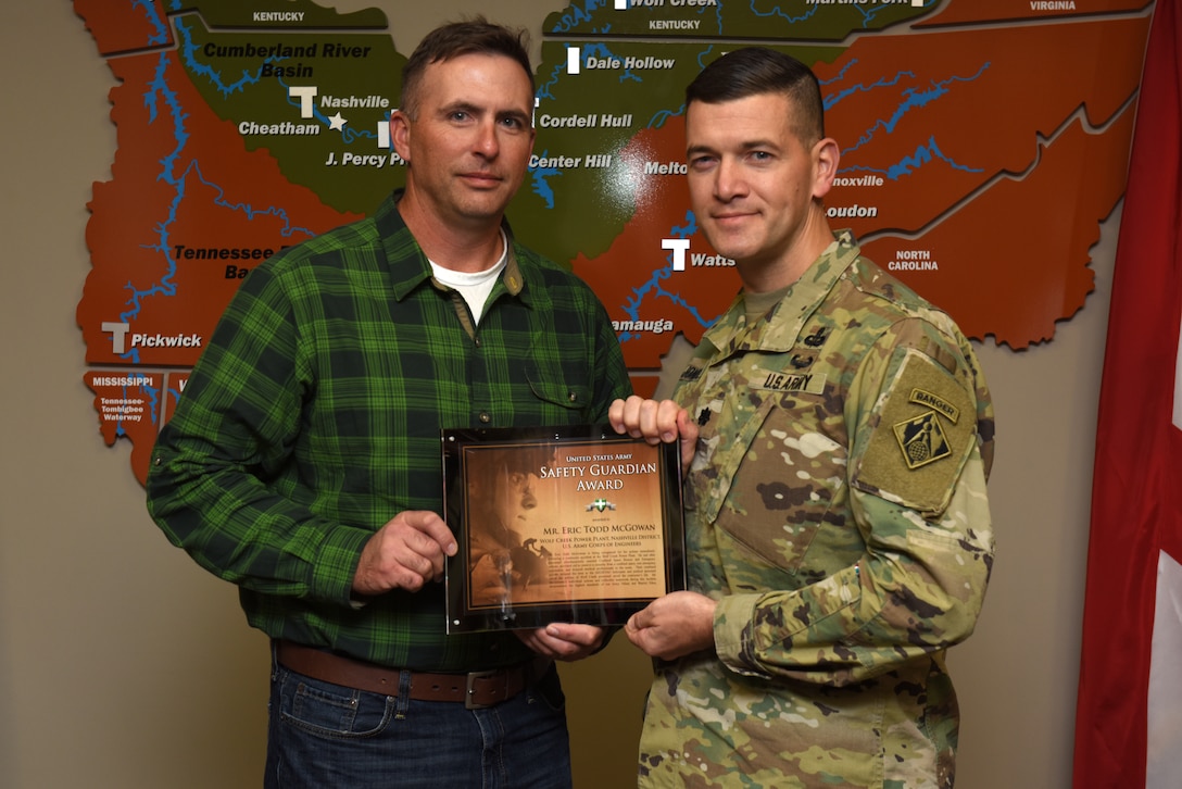 Lt. Col. Cullen Jones, U.S. Army Corps of Engineers Nashville District commander, presents the United States Army Safety Guardian Award to Eric Todd McGowan, Power Plant maintenance worker, during a ceremony Nov. 15, 2018 at the Nashville District Headquarters in Nashville, Tenn. McGowan is one of five employees whose quick actions to evacuate an injured contractor from a confined space July 9, 2018 at Wolf Creek Dam in Jamestown, Ky., reduced the time it took for the victim to receive life-saving medical treatment. (USACE photo by Lee Roberts)