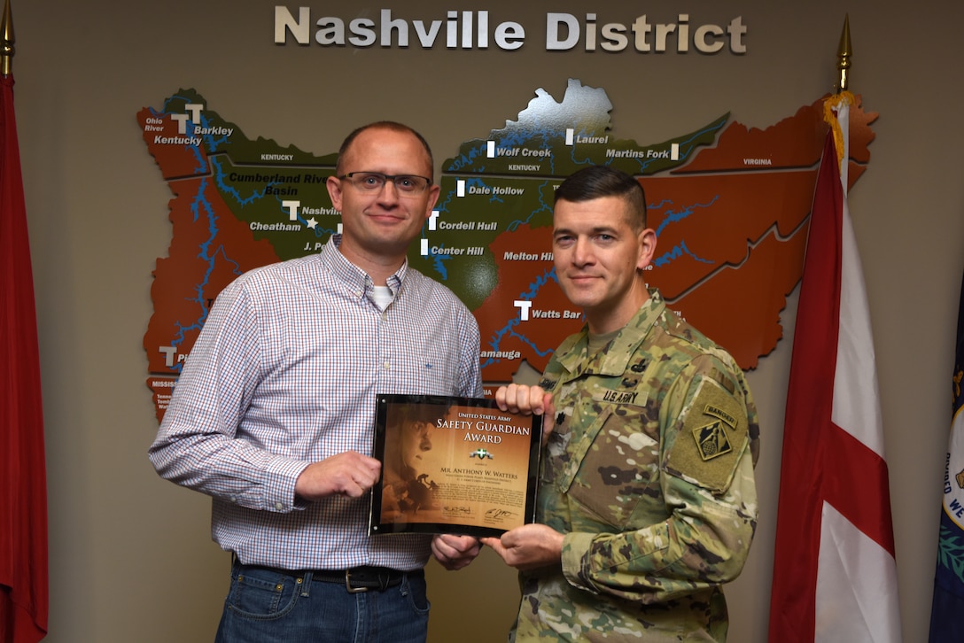 Lt. Col. Cullen Jones, U.S. Army Corps of Engineers Nashville District commander, presents the United States Army Safety Guardian Award to Anthony Watters, Wolf Creek Dam Power Plant superintendent, during a ceremony Nov. 15, 2018 at the Nashville District Headquarters in Nashville, Tenn. Watters is one of five employees whose quick actions to evacuate an injured contractor from a confined space July 9, 2018 at Wolf Creek Dam in Jamestown, Ky., reduced the time it took for the victim to receive life-saving medical treatment. (USACE photo by Lee Roberts)