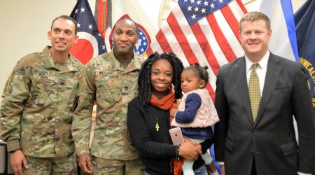 Two Soldiers, woman holding baby, and Under Secretary McCarthy