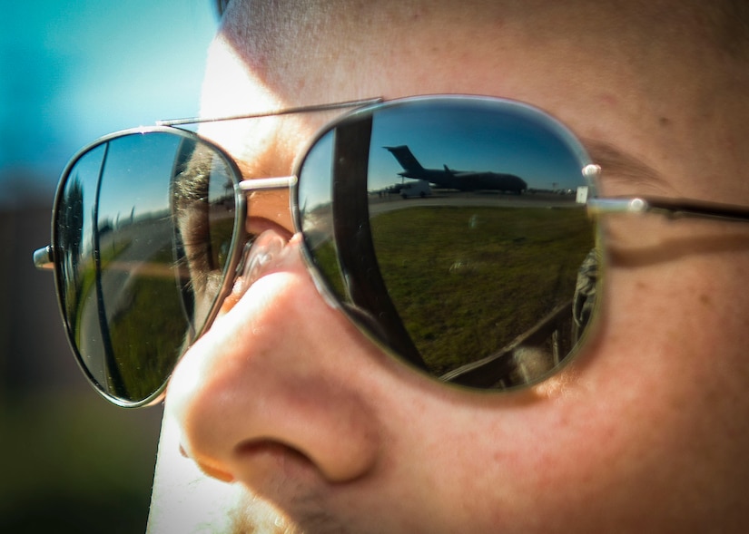 Airman 1st Class Derek Riley, 437th Aircraft Maintenance Squadron maintainer, looks out at a C-17 Globemaster III being loaded during a readiness exercise Nov. 16, 2018 at Joint Base Charleston, S.C. To keep the training as realistic as possible, participants from across JB Charleston received the equipment, weapons and specialty uniform items they would use in real-world situations. The simulated scenarios enabled senior base leaders and subject matter experts to ensure the readiness of JB Charleston’s quick response capabilities.