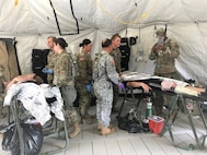 Airmen and Soldiers care for victims at a mobile medical facility during a simulated chemical response for the 503rd Military Police Battalion field training exercise (FTX) at Camp Blanding, Fla., on Oct. 24, 2018. The members, who prepare for chemical, biological, radiological and nuclear (CBRN) catastrophes are part of the Joint Task Force Civil Support, Defense CBRN Response Force (DCRF). (Courtesy photo by Navy Chief Petty Officer Zach McKinley)