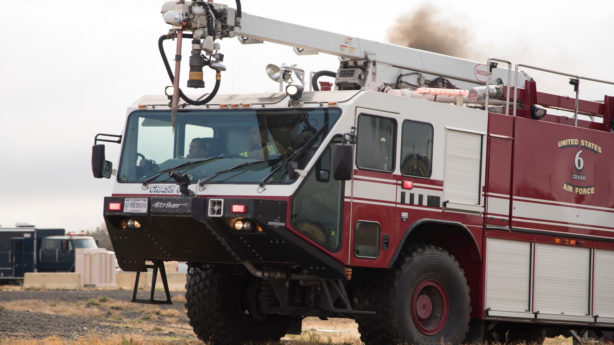 92nd Civil Engineering Squadron firefighters drive into a training area during demonstration of the bases emergency response capabilities to members of the Spokane Local Emergency Planning Committee at Fairchild Air Force Base, Washington, Nov. 7, 2018. The LEPC meets at different locations monthly to help survey local disaster response capabilities and Team Fairchild volunteered to host during the month of November as a way to demonstrate the specialized resources the base can offer to the local community. (U.S. Air Force Photo/ Senior Airman Ryan Lackey)