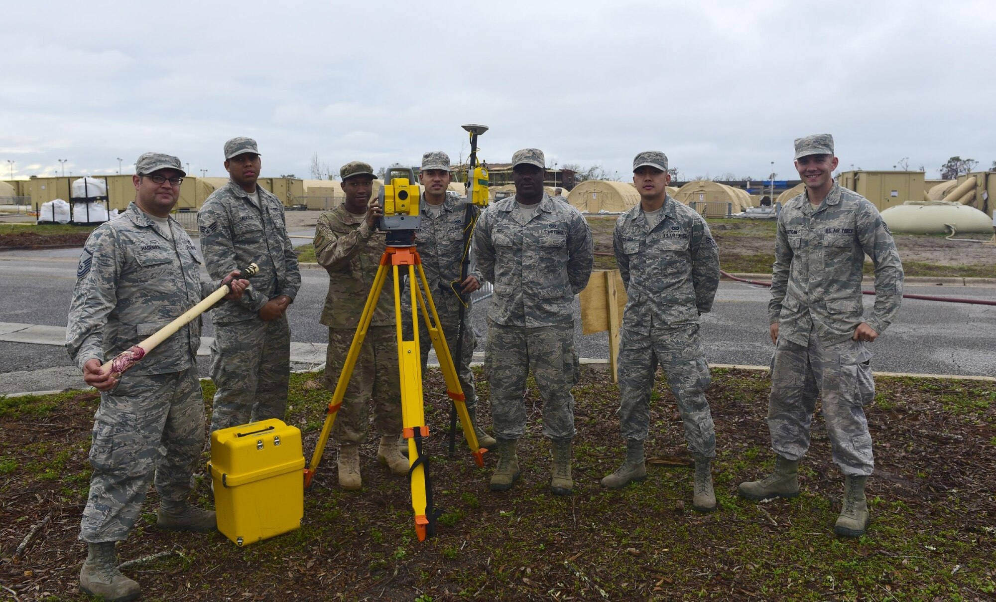 U.S. Air Force engineering technicians pose for a group photo in front of the “tent city” they helped plan and organize at Tyndall Air Force Base, Fla., Nov. 14, 2018. Engineering technicians who specialize in planning and managing construction projects have come to Tyndall Air Force Base to assist in planning the rebuild effort. These engineering technicians from multiple bases have the responsibility of ensuring that every base has the facilities and structures they need to keep operating successfully. With tasks that include surveying, computer-aided drafting and soil testing. (U.S. Air Force photo by Senior Airman Cody R. Miller)