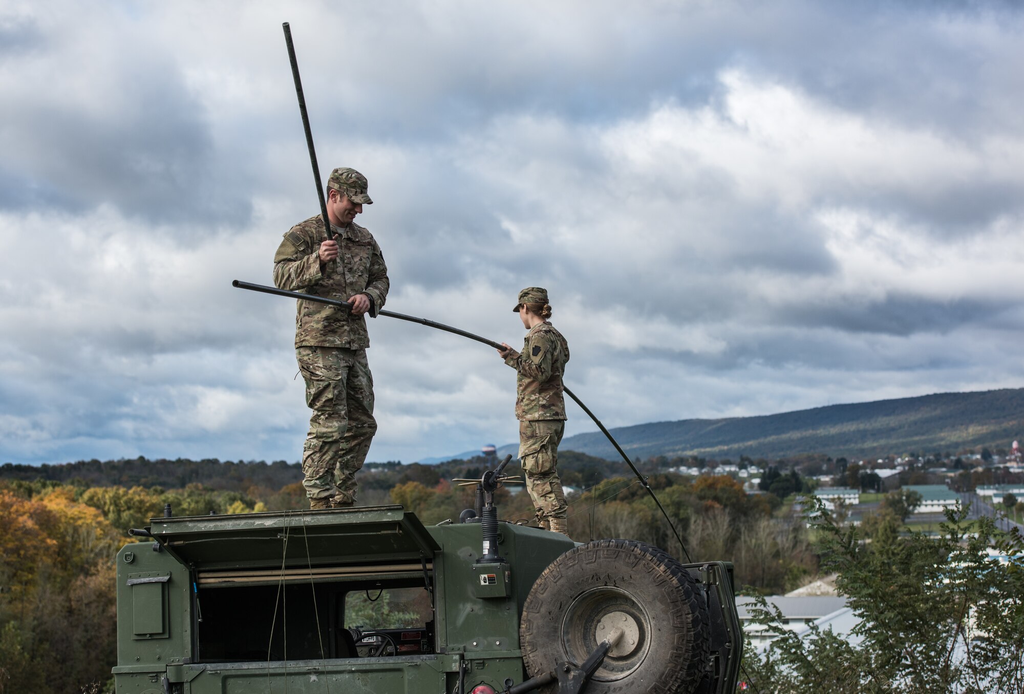 Staff Sgt. Patrick Kluyber and Staff Sgt. Chloe Rangel, both radio frequency transmission systems supervisors with the 148th Air Support Operations Squadron, Pennsylvania Air National Guard, assemble a whip antenna to mount on a Humvee.