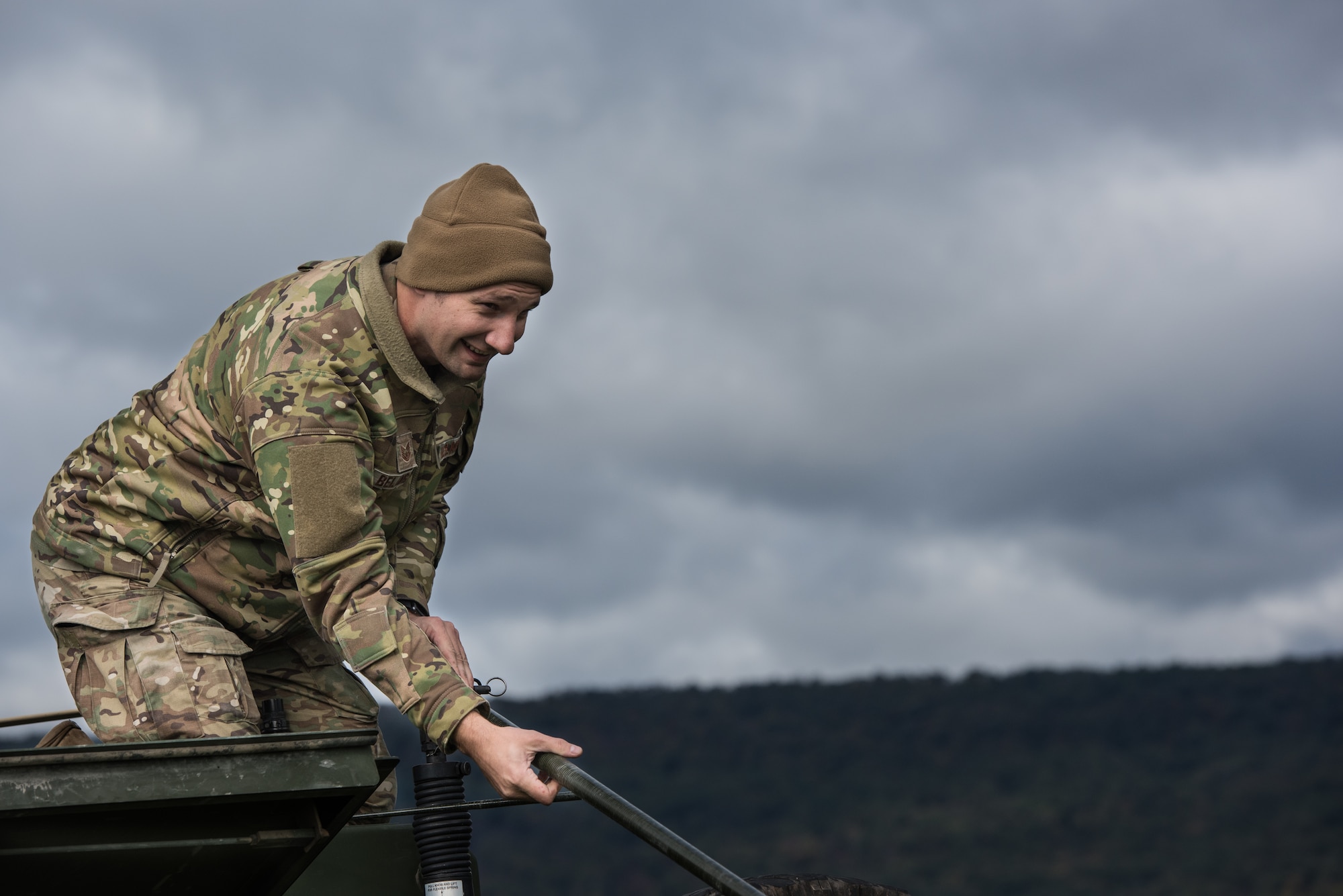 Tech. Sgt. Nathan Belanger, a radio frequency transmission systems supervisor with the 148th Air Support Operations Squadron, Pennsylvania Air National Guard, helps raise a whip antenna on a Humvee.