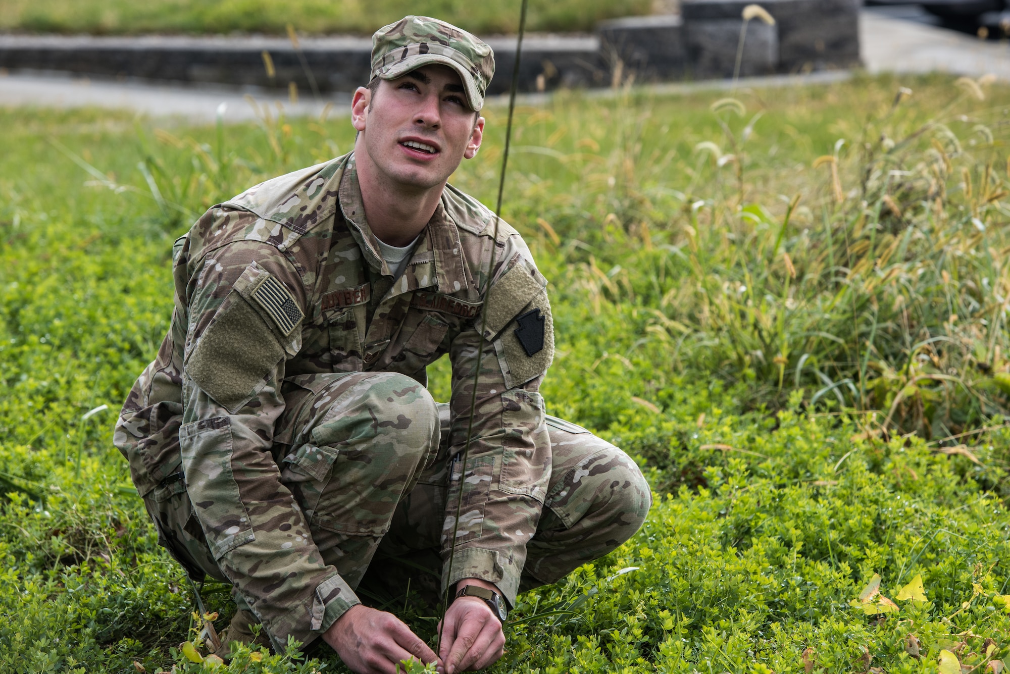 Staff Sgt. Patrick Kluyber, a radio frequency transmission systems supervisor with the 148th Air Support Operations Squadron, Pennsylvania Air National Guard, stakes down a guide-wire from a Humvee-mounted whip antenna.