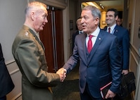 Marine Corps Gen. Joe Dunford, chairman of the Joint Chiefs of Staff, greets Turkish Minister of Defense Hulusi Akar, during the Halifax International Security Forum Nov. 17, 2018.