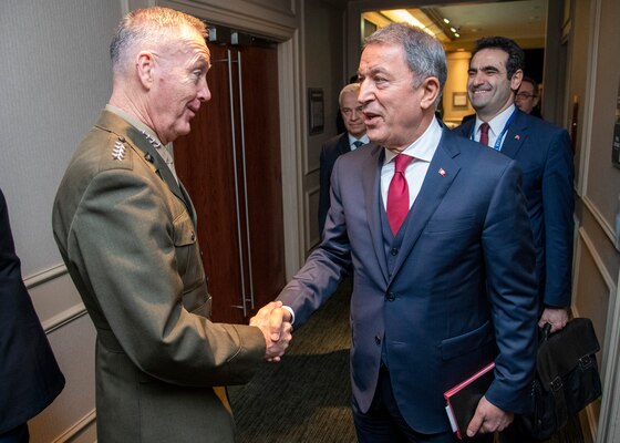 Marine Corps Gen. Joe Dunford, chairman of the Joint Chiefs of Staff, greets Turkish Minister of Defense Hulusi Akar, during the Halifax International Security Forum Nov. 17, 2018.