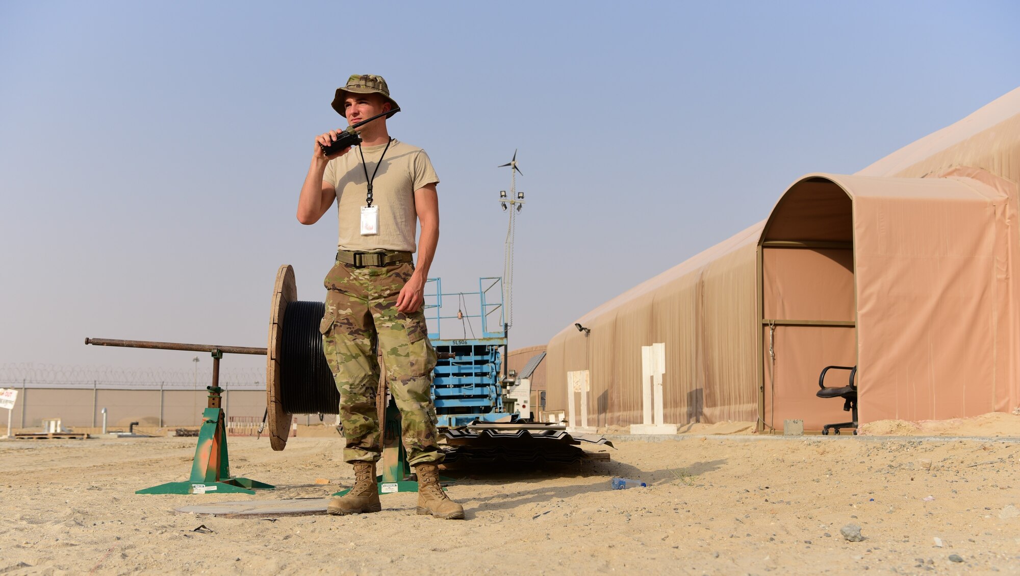 Senior Airman Joshua Morgan, 386th Expeditionary Civil Engineer Squadron force protection specialist, radios to other members of his team Oct. 18, 2018, at an undisclosed location in Southwest Asia. Force protection Airmen ensure security in the deployed area of responsibility by augmenting security forces and monitoring contracted workers on and off their respective bases. (U.S. Air Force photo by Staff Sgt. Christopher Stoltz)