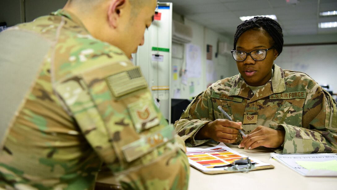 Staff Sgt. Akina Jones, 386th Expeditionary Civil Engineer Squadron force protection specialist, speaks to a fellow FP Airman Oct. 18, 2018, at an undisclosed location in Southwest Asia. Jones and her fellow force protection Airmen are comprised of individuals from more than 50 Air Force specialty codes. (U.S. Air Force photo by Staff Sgt. Christopher Stoltz)