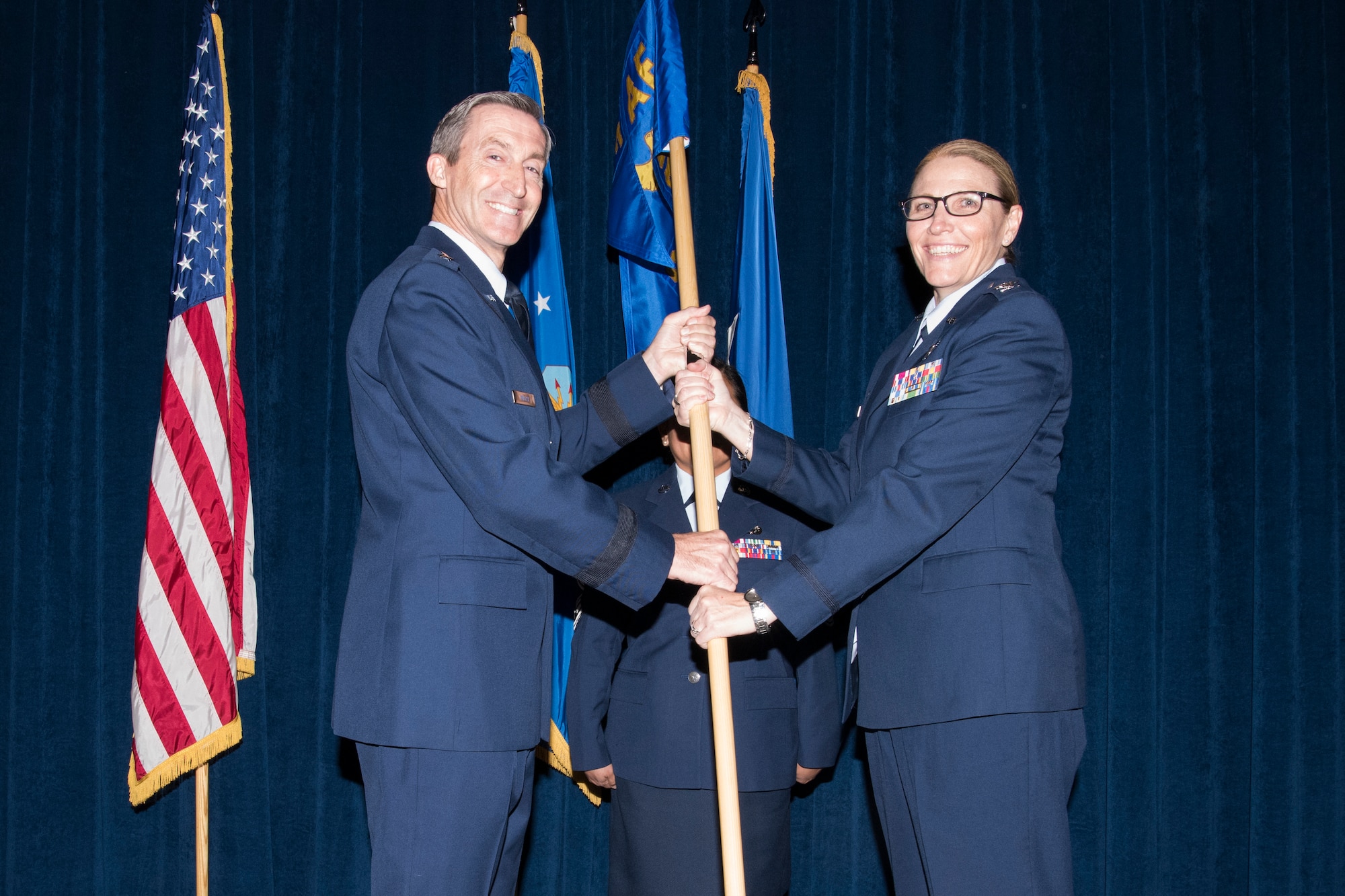 Maj. Gen. Ronald “Bruce” Miller, 10th Air Force commander, passes the guidon to Col. Lori Jones during a ceremony at Joint Base San Antonio-Lackland, Texas, Nov. 18, in which the 960th Cyberspace Wing was activated.