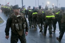 Master Chief Leonardo E. Carbonel motivates Sailors with 3rd Dental Battalion, 3rd Marine Logistics Group, during a 3-mile hike Nov. 16, 2018 at Camp Hansen, Okinawa, Japan. 3rd Dental Battalion Sailors participated in a 3-mile conditioning hike to simulate hiking with deployed Marines and traveling to a Role II facility, as well as conducting Tactical Combat Casualty Care upon arrival. Carbonel, a native of Lemoore, California, is the command master chief for 3rd Dental Battalion. (U.S. Marine Corps photo by Lance Cpl. Armando Elizalde)