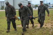 Sailors use a stretcher to transport notional casualties during a triage care scenario Nov. 16, 2018 at Camp Hansen, Okinawa, Japan. Sailors from dental clinics on Okinawa participated in Tactical Casualty Care to reinforce the basics of triage care for personnel involved in combat operations with support from Sailors with 3rd Medical Battalion, 3rd Marine Logistics Group. The various scenarios were chosen to depict common injuries that are seen during deployments. (U.S. Marine Corps photo by Lance Cpl. Armando Elizalde)