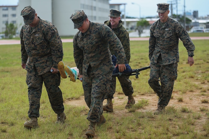 Sailors use a stretcher to transport notional casualties during a triage care scenario Nov. 16, 2018 at Camp Hansen, Okinawa, Japan. Sailors from dental clinics on Okinawa participated in Tactical Casualty Care to reinforce the basics of triage care for personnel involved in combat operations with support from Sailors with 3rd Medical Battalion, 3rd Marine Logistics Group. The various scenarios were chosen to depict common injuries that are seen during deployments. (U.S. Marine Corps photo by Lance Cpl. Armando Elizalde)