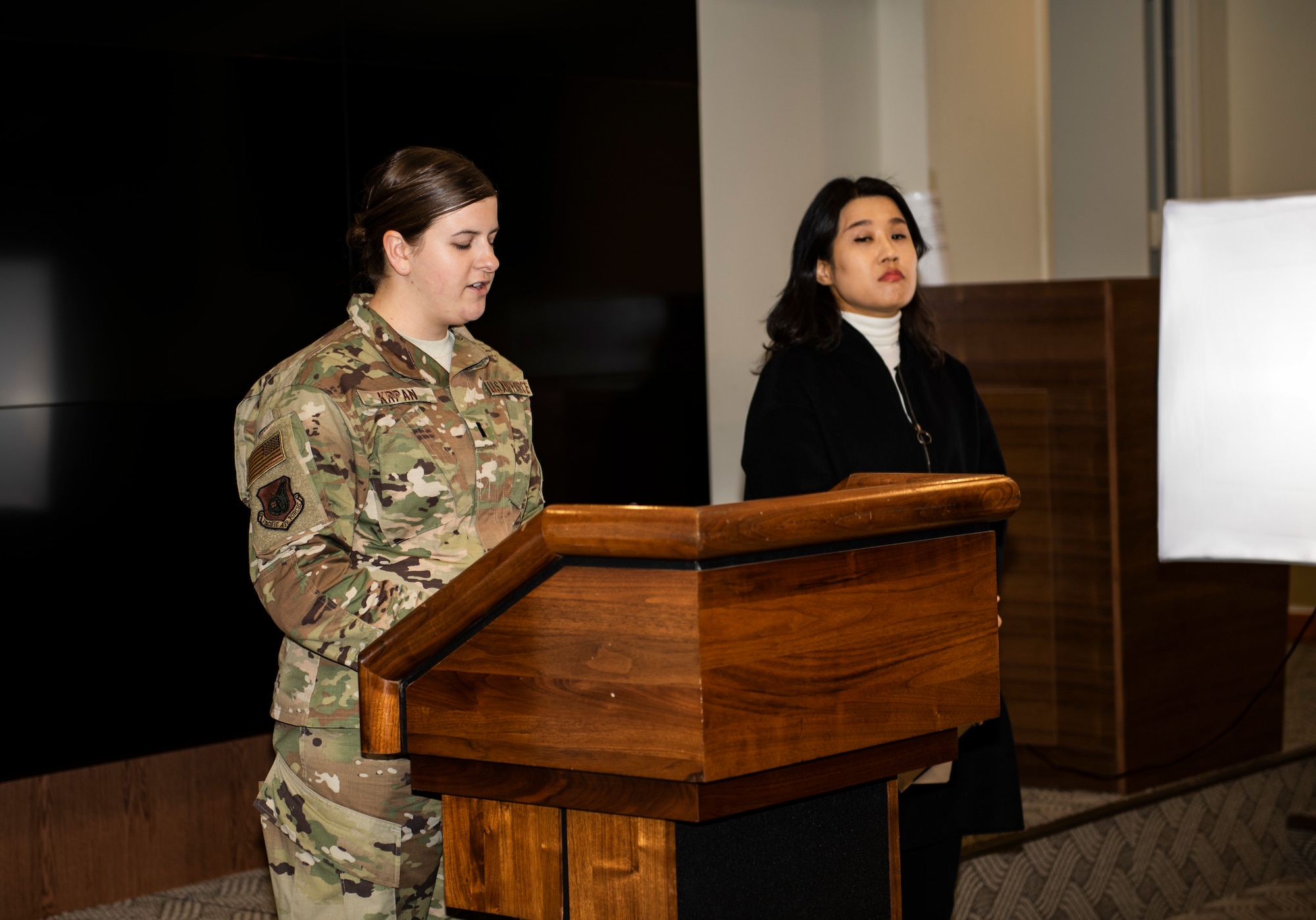 U.S. Air Force 1st Lt. Madeline Krpan, 8th Fighter Wing command information section chief, gives a briefing at a simulated press conference at Kunsan Air Base, Republic of Korea, Oct. 31, 2018. The 8th FW conducted training including answering queries from simulated media in response to a mock aircraft mishap. (U.S. Air Force photo by Senior Airman Stefan Alvarez)